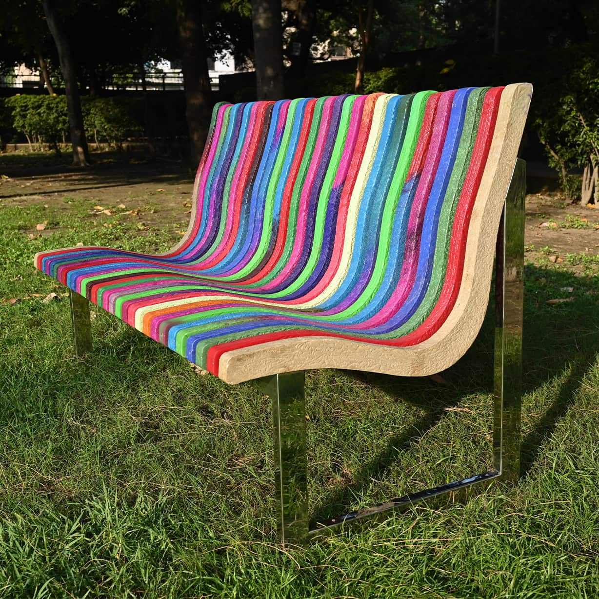 Rainbow outdoor bench made with 100% recycled plastic eco friendly seating solution.